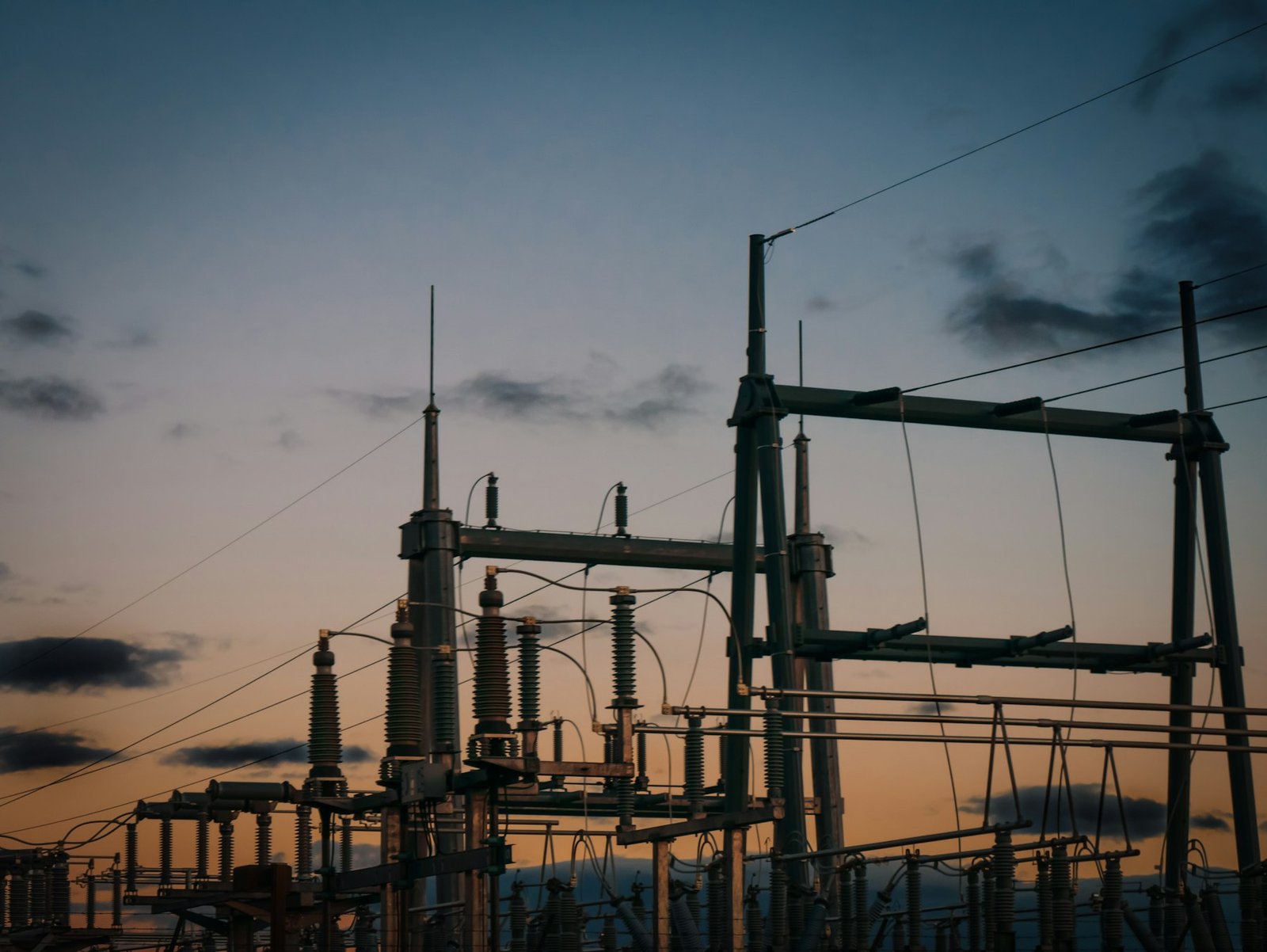 Transmission lines and pylons carrying power across an open sky